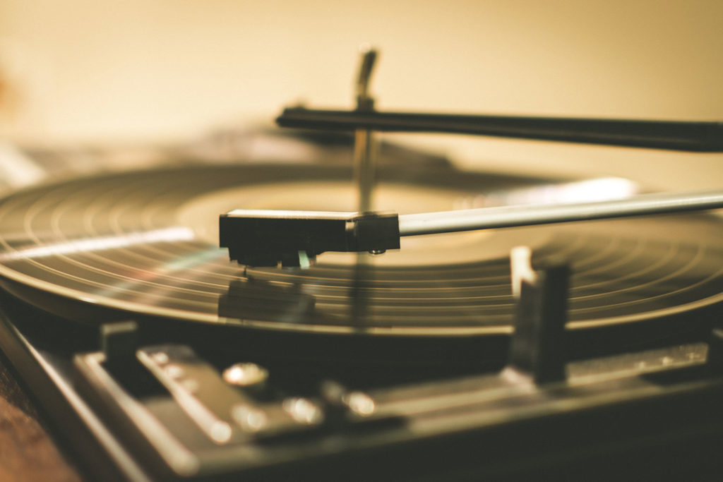Sepia-toned close-up of a vinyl record and record player needle